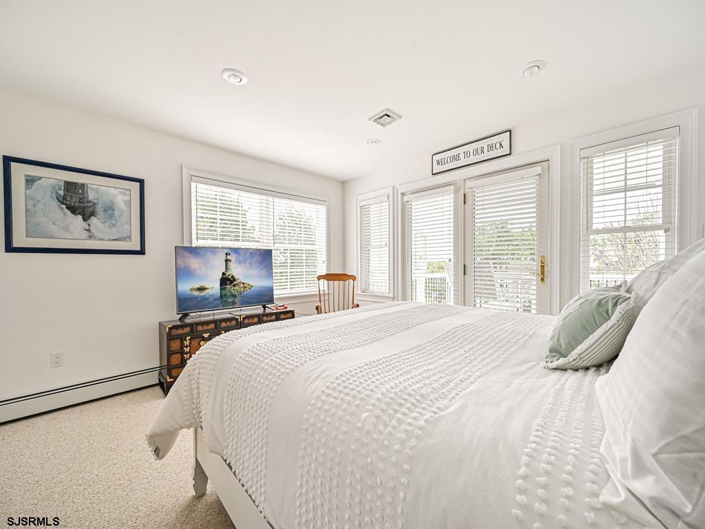 2304 Ocean Avenue Brigantine, NJ 08203 - Photo 23 of 27 a bedroom with a large bed and a window