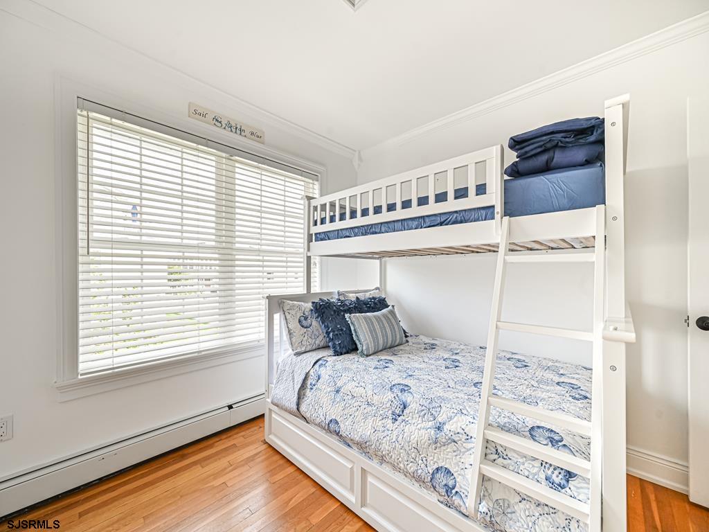 2304 Ocean Avenue Brigantine, NJ 08203 - Photo 24 of 27 a bedroom with a large bed and a window