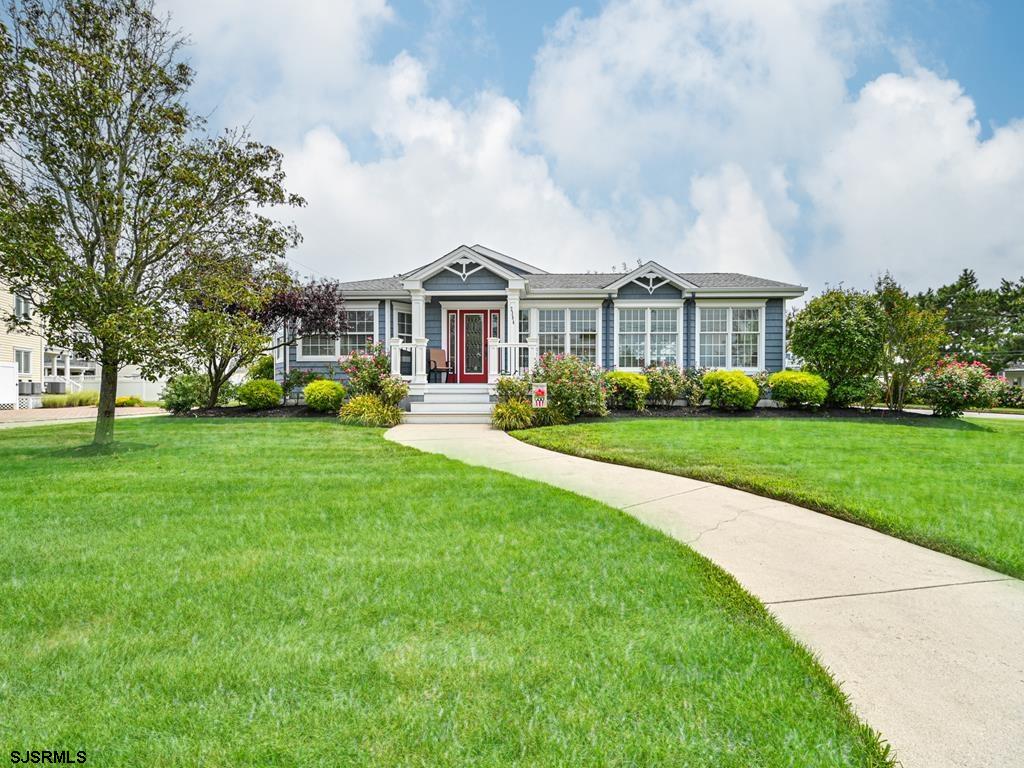 2304 Ocean Avenue Brigantine, NJ 08203 - Photo 4 of 27 a front view of a house with a garden and trees