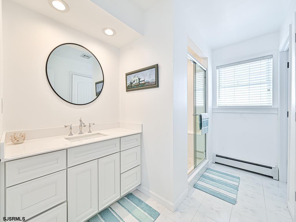 2304 Ocean Avenue Brigantine, NJ 08203 - Photo 7 of 27 a bathroom with a sink and a mirror