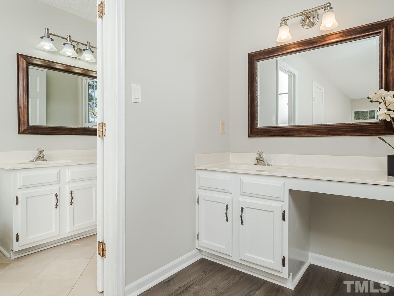 1901 Grove Point Court Raleigh, NC 27609 - Photo 14 of 26 a bathroom with a sink vanity and mirror