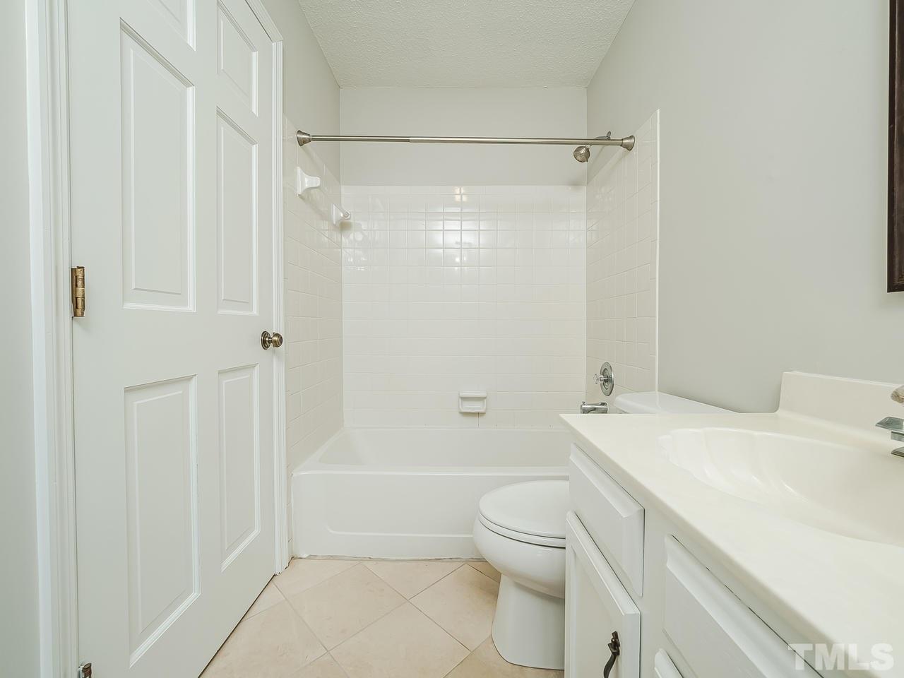 1901 Grove Point Court Raleigh, NC 27609 - Photo 15 of 26 a bathroom with a sink a toilet and shower