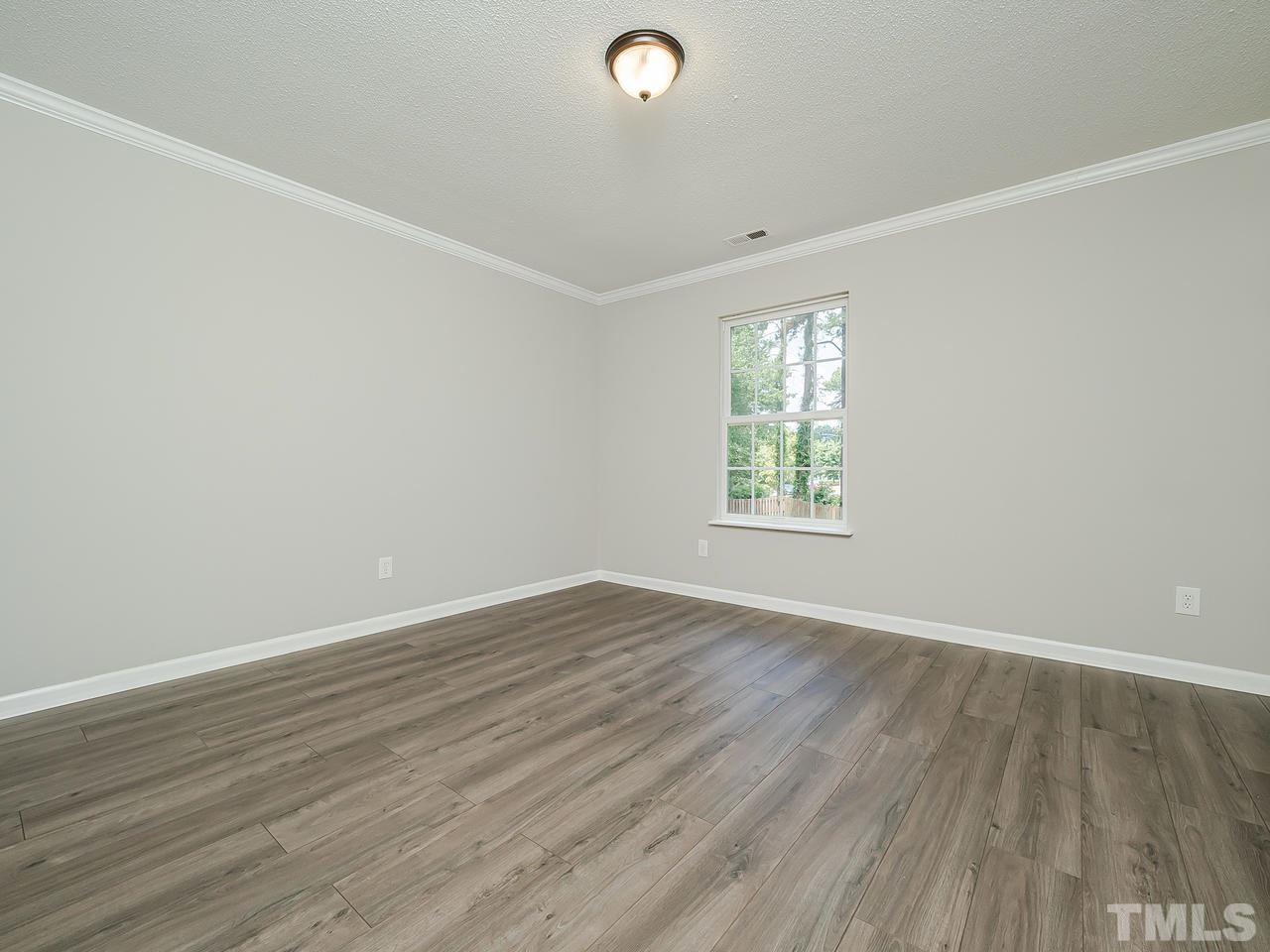 1901 Grove Point Court Raleigh, NC 27609 - Photo 19 of 26 an empty room with wooden floor and windows
