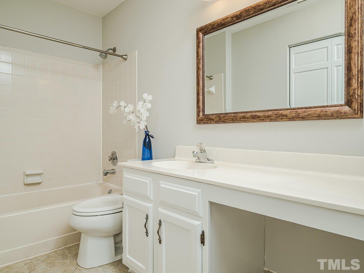 1901 Grove Point Court Raleigh, NC 27609 - Photo 20 of 26 a bathroom with a sink a toilet and shower