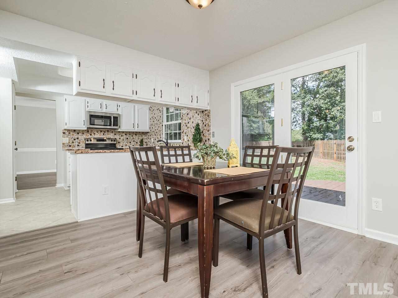 1901 Grove Point Court Raleigh, NC 27609 - Photo 10 of 26 a view of a dining room with furniture and wooden floor