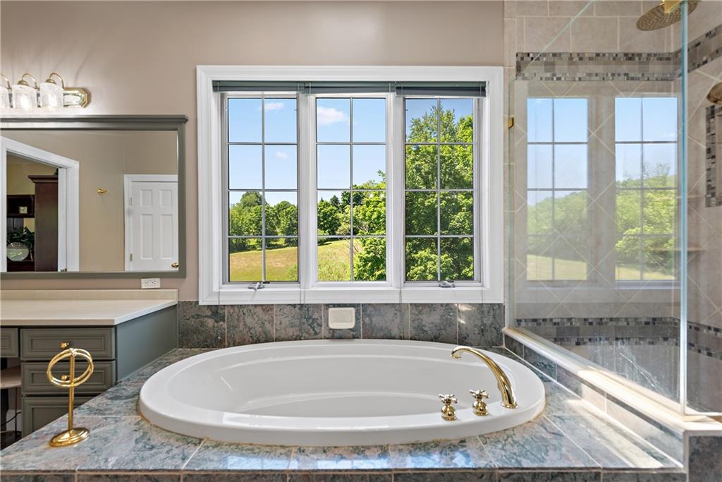 548 Lang Road Sewickley, PA 15143 - Photo 18 of 49 a bathroom with bathtub and window