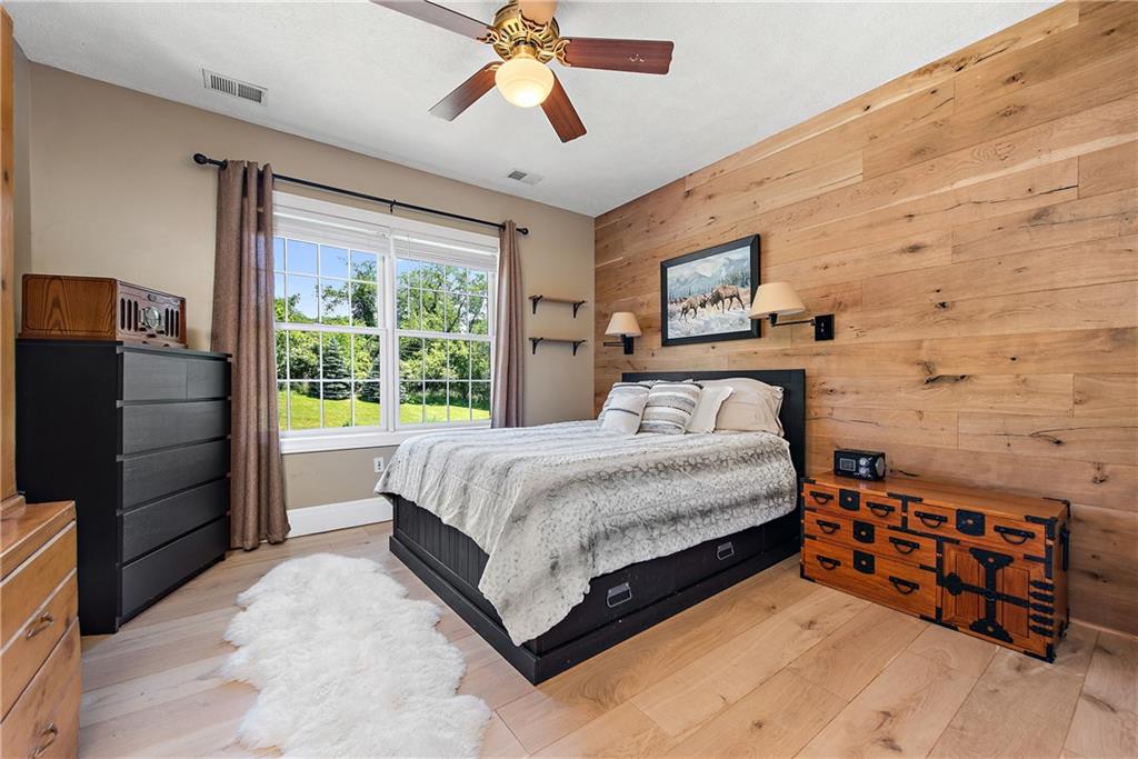 548 Lang Road Sewickley, PA 15143 - Photo 20 of 49 a bedroom with a bed and a flat tv screen