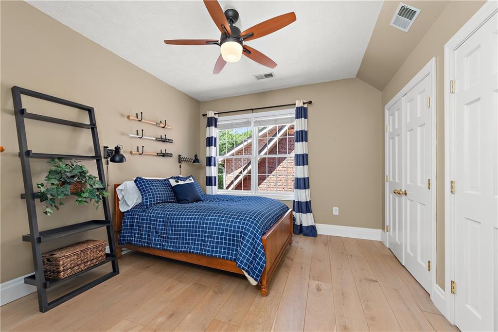 548 Lang Road Sewickley, PA 15143 - Photo 22 of 49 a bedroom with a bed rug and wooden floor