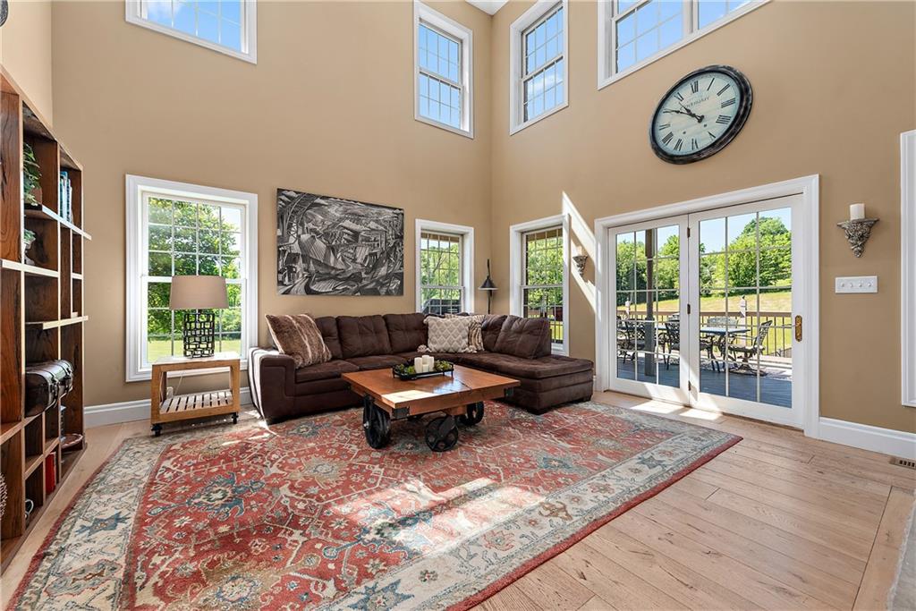 548 Lang Road Sewickley, PA 15143 - Photo 4 of 49 a living room with furniture a large window and a clock
