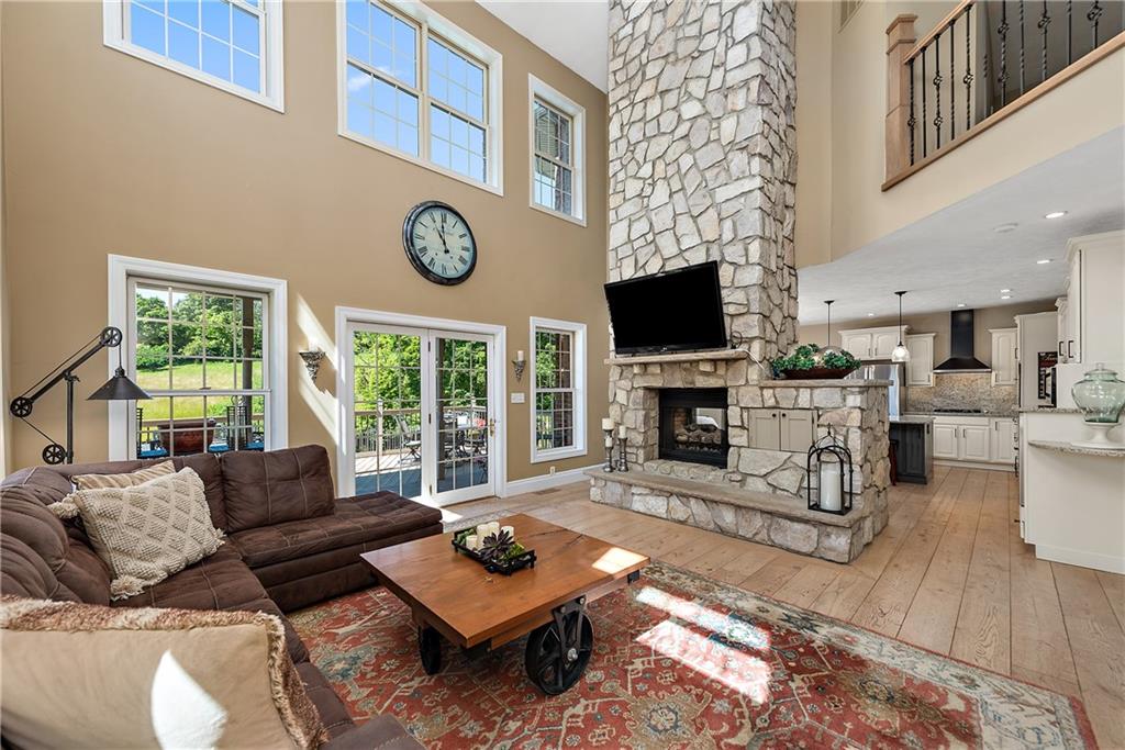 548 Lang Road Sewickley, PA 15143 - Photo 5 of 49 a living room with furniture a fireplace and a flat screen tv