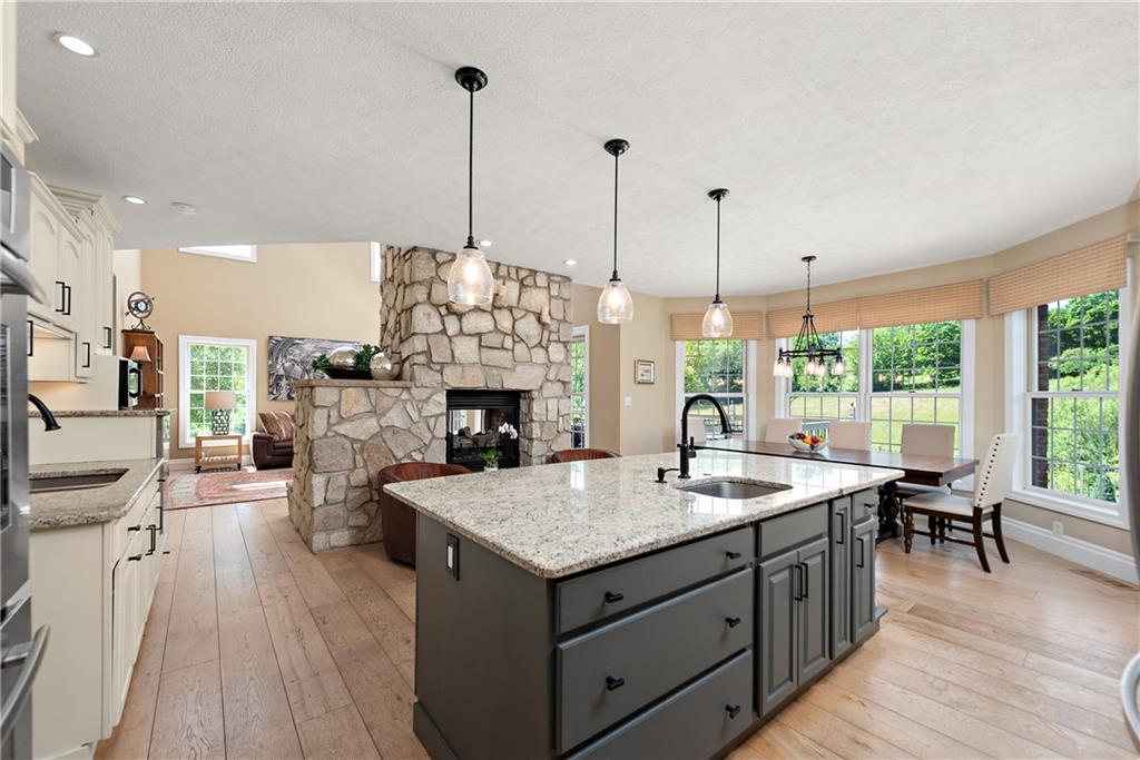548 Lang Road Sewickley, PA 15143 - Photo 8 of 49 a living room with furniture a fireplace and a table