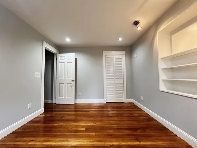 a view of room with wooden floor