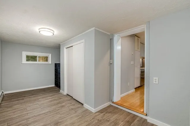 a view of hallway with wooden floor