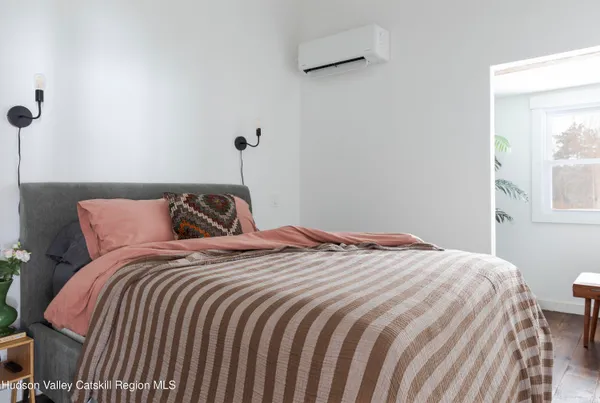a bedroom with a bed and a window