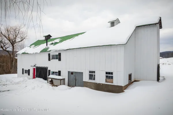 a bedroom with furniture and natural light
