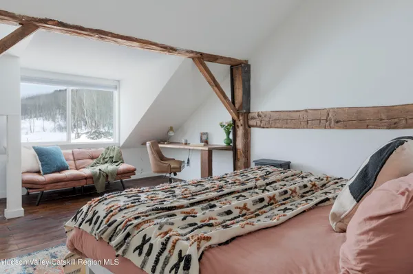 a bedroom with two beds and a couch