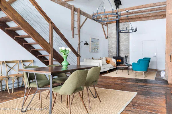 a dining room with furniture a chandelier and wooden floor
