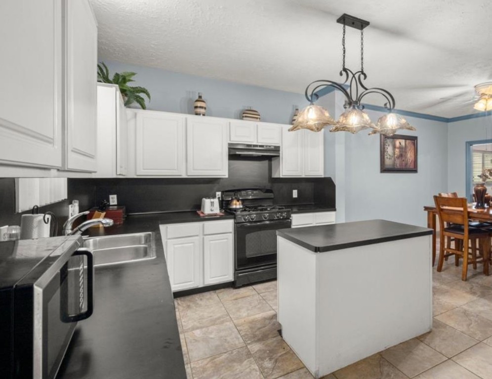 15919 Timber Chase Drive Houston, TX 77082 - Photo 2 of 6 a kitchen with a stove cabinets and a stove top oven