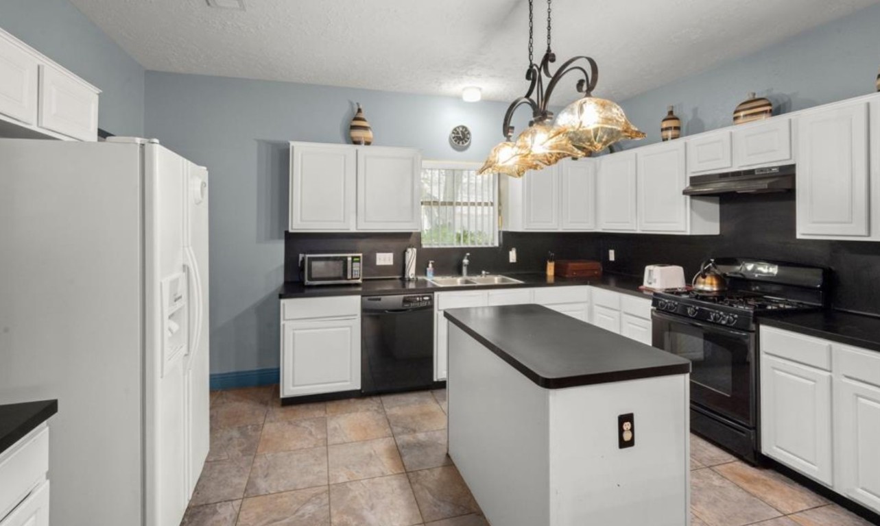15919 Timber Chase Drive Houston, TX 77082 - Photo 4 of 6 a kitchen with granite countertop a sink a counter top space and stainless steel appliances