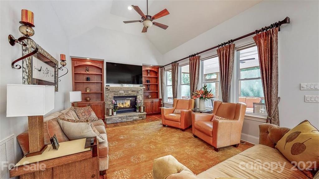 8116 Balcony Bridge Road Huntersville, NC 28078 - Photo 11 of 31 a living room with furniture a fireplace and a flat screen tv