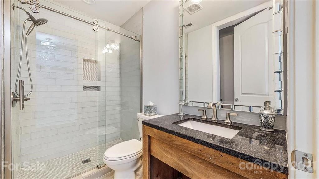 8116 Balcony Bridge Road Huntersville, NC 28078 - Photo 21 of 31 a bathroom with a granite countertop sink toilet and shower