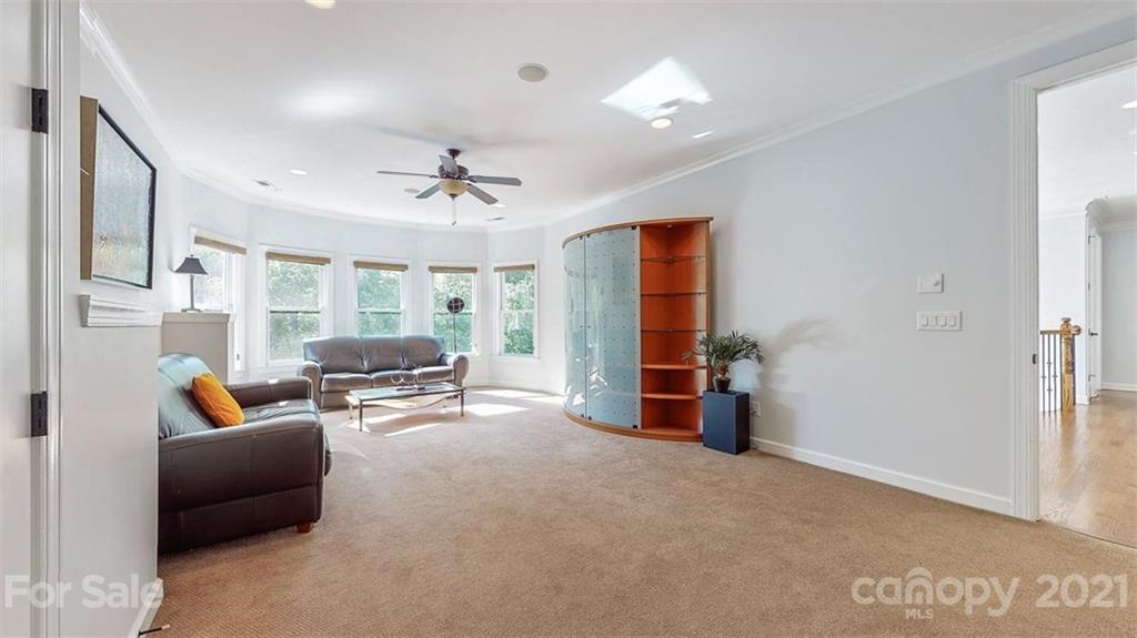 8116 Balcony Bridge Road Huntersville, NC 28078 - Photo 24 of 31 a living room with furniture and a chandelier