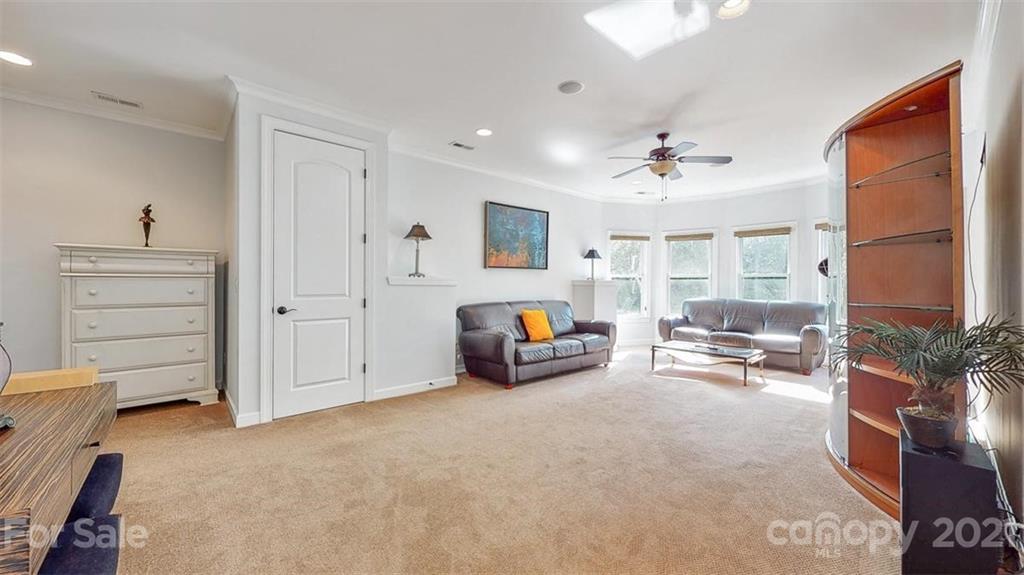 8116 Balcony Bridge Road Huntersville, NC 28078 - Photo 25 of 31 a living room with furniture and a chandelier