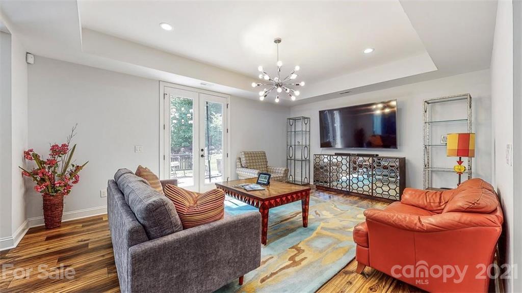 8116 Balcony Bridge Road Huntersville, NC 28078 - Photo 28 of 31 a living room with furniture a flat screen tv and a chandelier