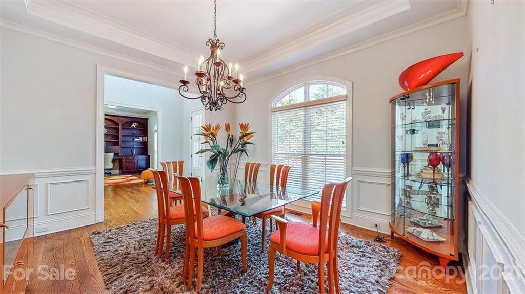 8116 Balcony Bridge Road Huntersville, NC 28078 - Photo 10 of 31 a dining room with furniture a chandelier and wooden floor