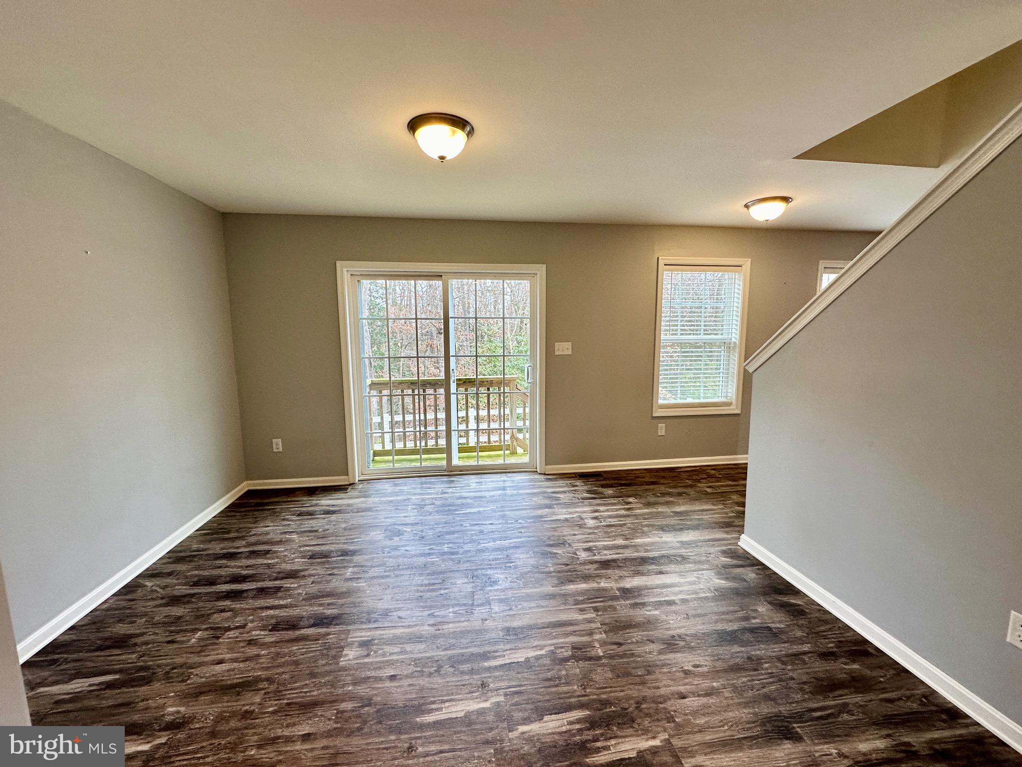 326 Sweeping Mist Circle Frederica, DE 19946 - Photo 12 of 37 a view of an empty room with wooden floor and a window
