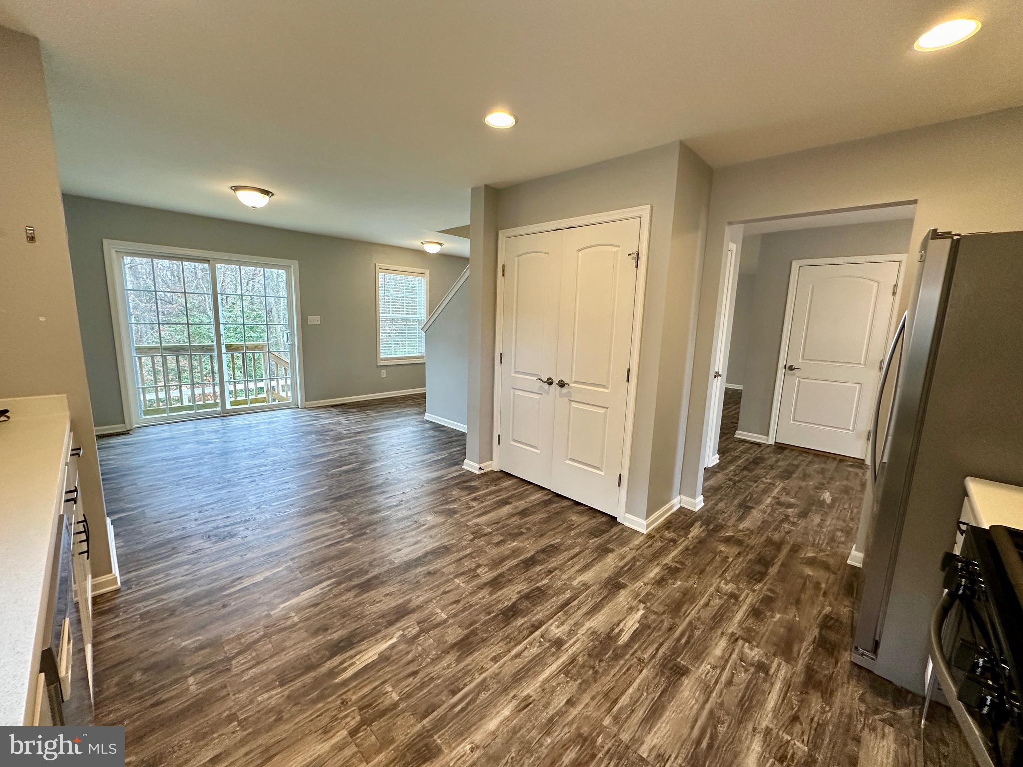 326 Sweeping Mist Circle Frederica, DE 19946 - Photo 16 of 37 an empty room with wooden floor and windows