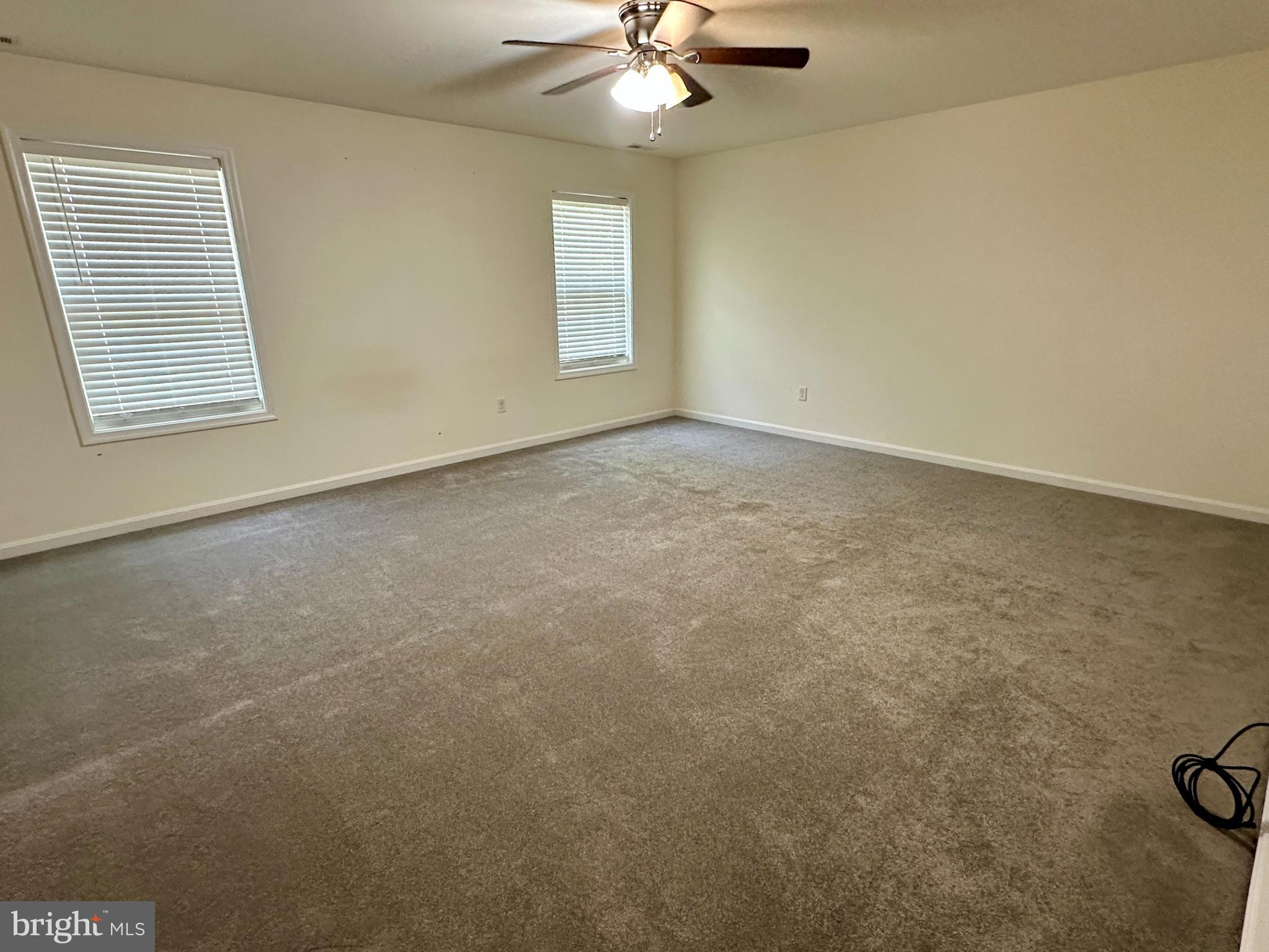 326 Sweeping Mist Circle Frederica, DE 19946 - Photo 19 of 37 an empty room with windows and fan