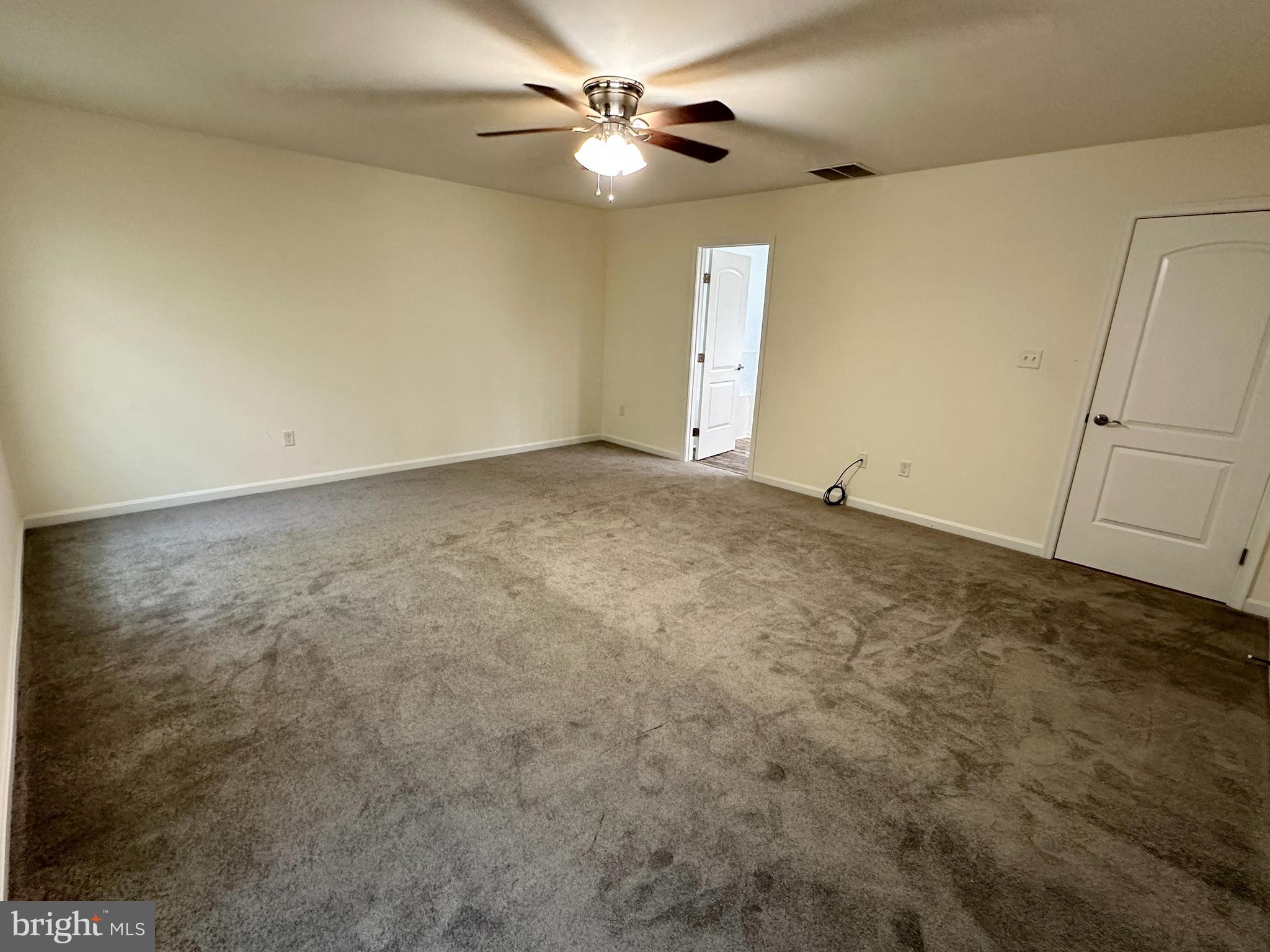 326 Sweeping Mist Circle Frederica, DE 19946 - Photo 21 of 37 an empty room with closet and a ceiling fan