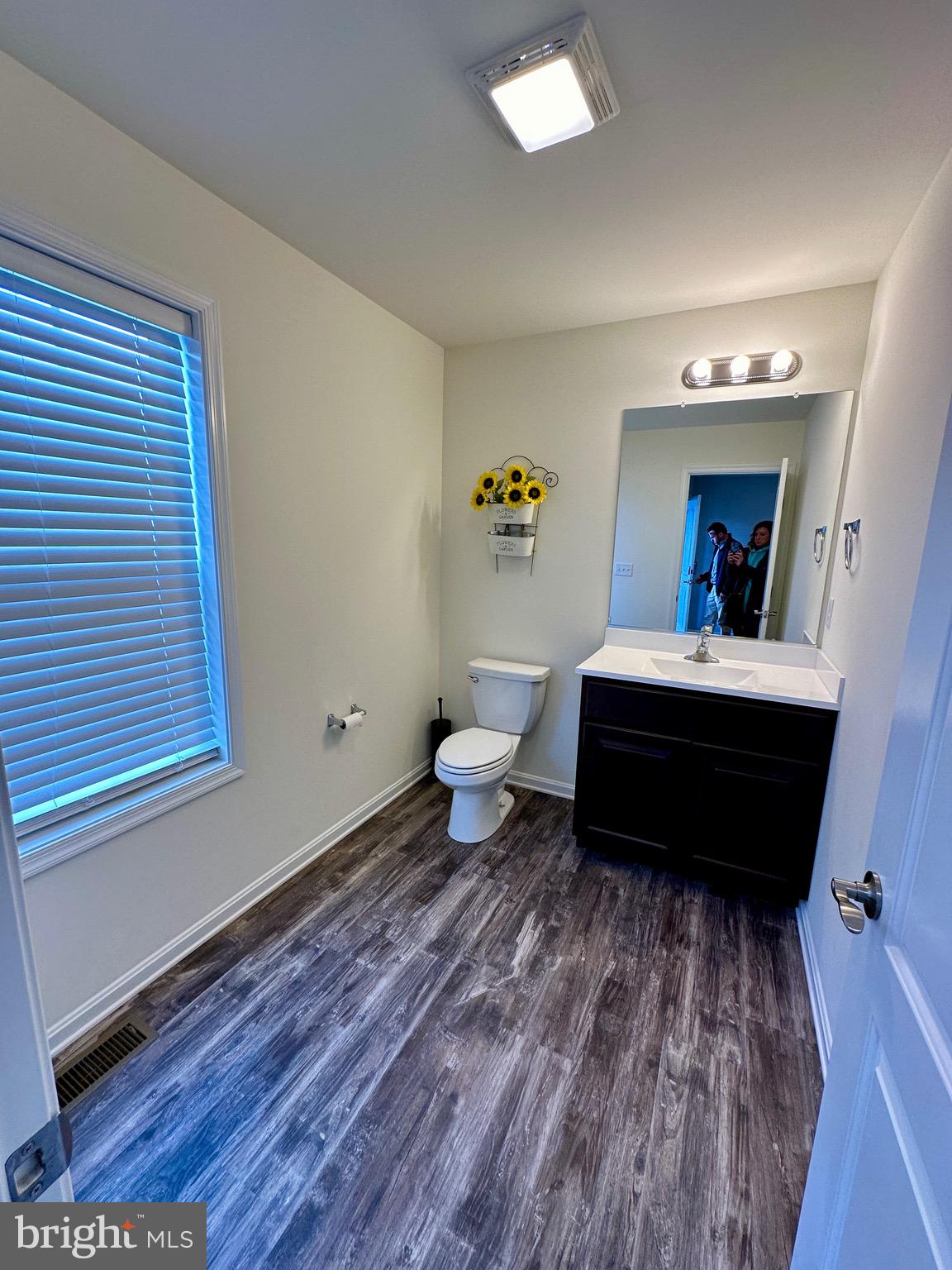 326 Sweeping Mist Circle Frederica, DE 19946 - Photo 22 of 37 a living room with a bed and a dresser