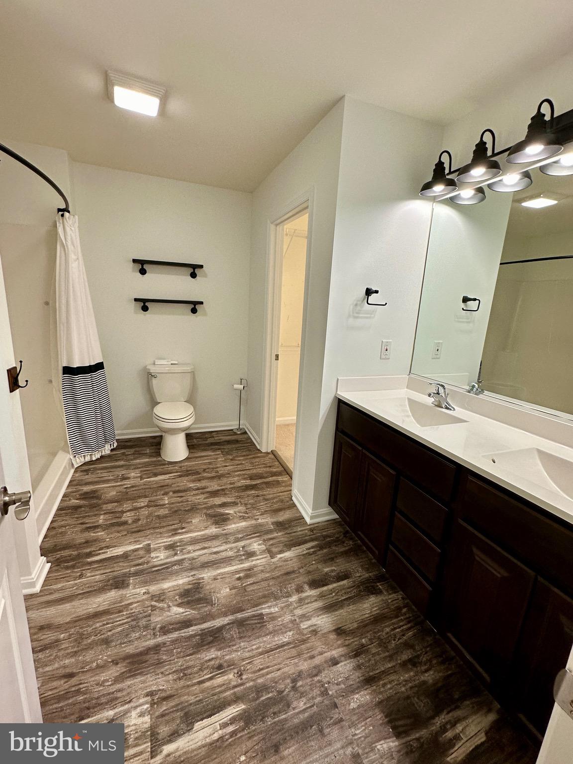 326 Sweeping Mist Circle Frederica, DE 19946 - Photo 24 of 37 a bedroom with a sink and a mirror