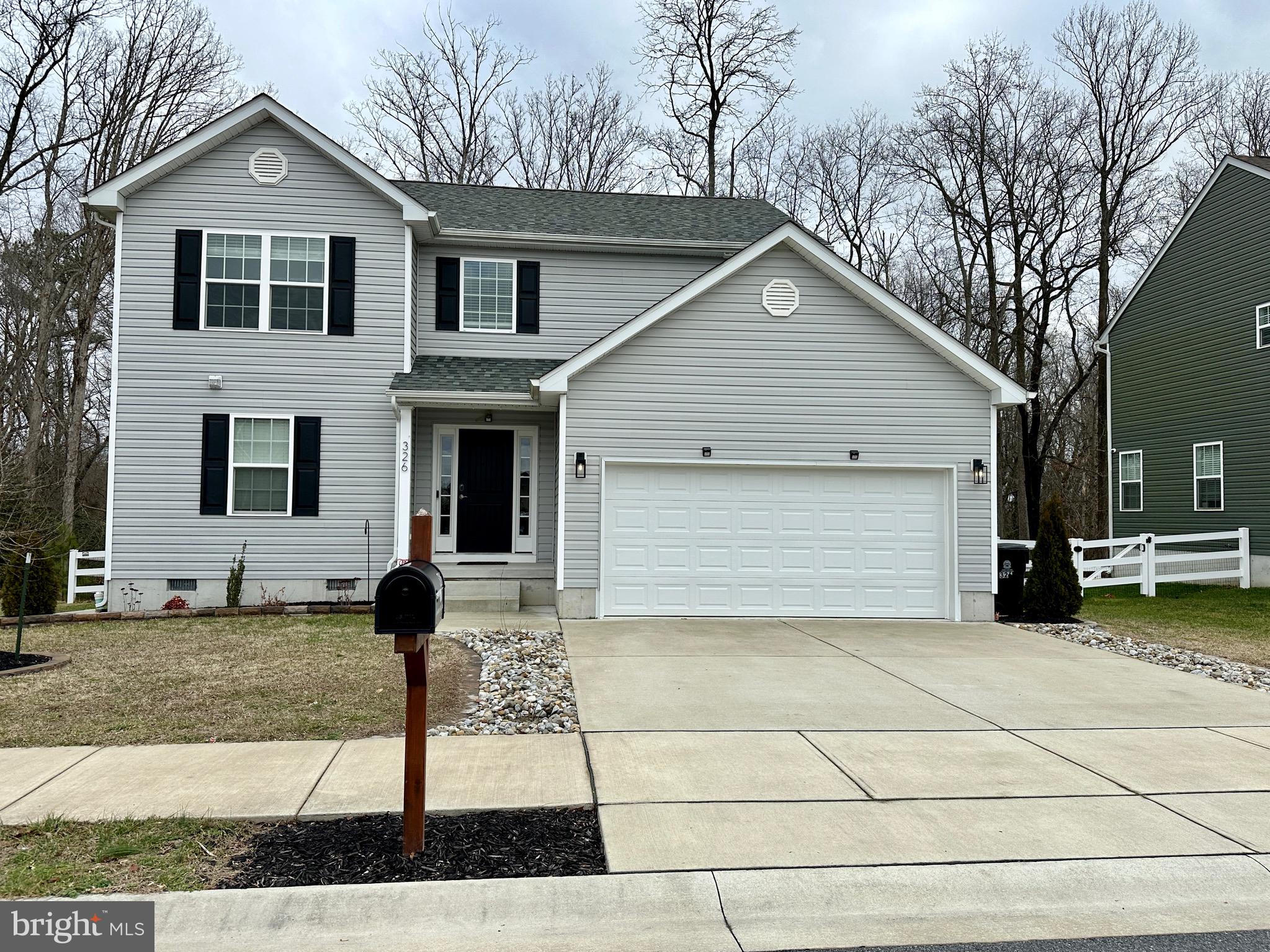 326 Sweeping Mist Circle Frederica, DE 19946 - Photo 36 of 37 a front view of a house with a yard and garage