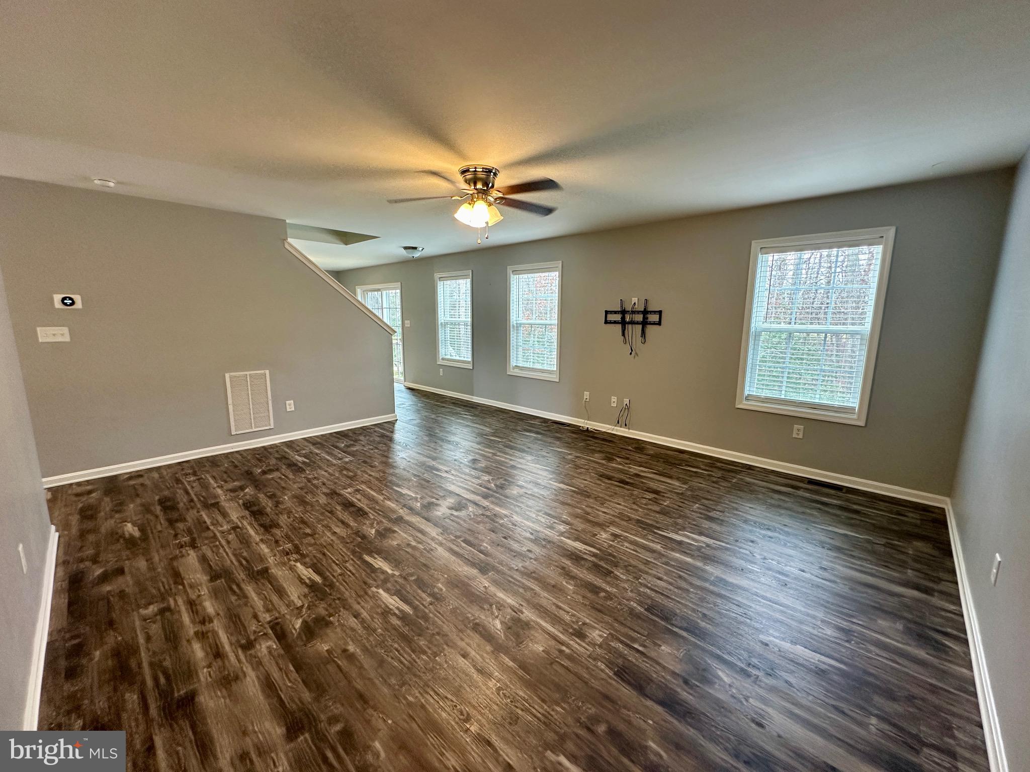 326 Sweeping Mist Circle Frederica, DE 19946 - Photo 8 of 37 wooden floor in an empty room with a window