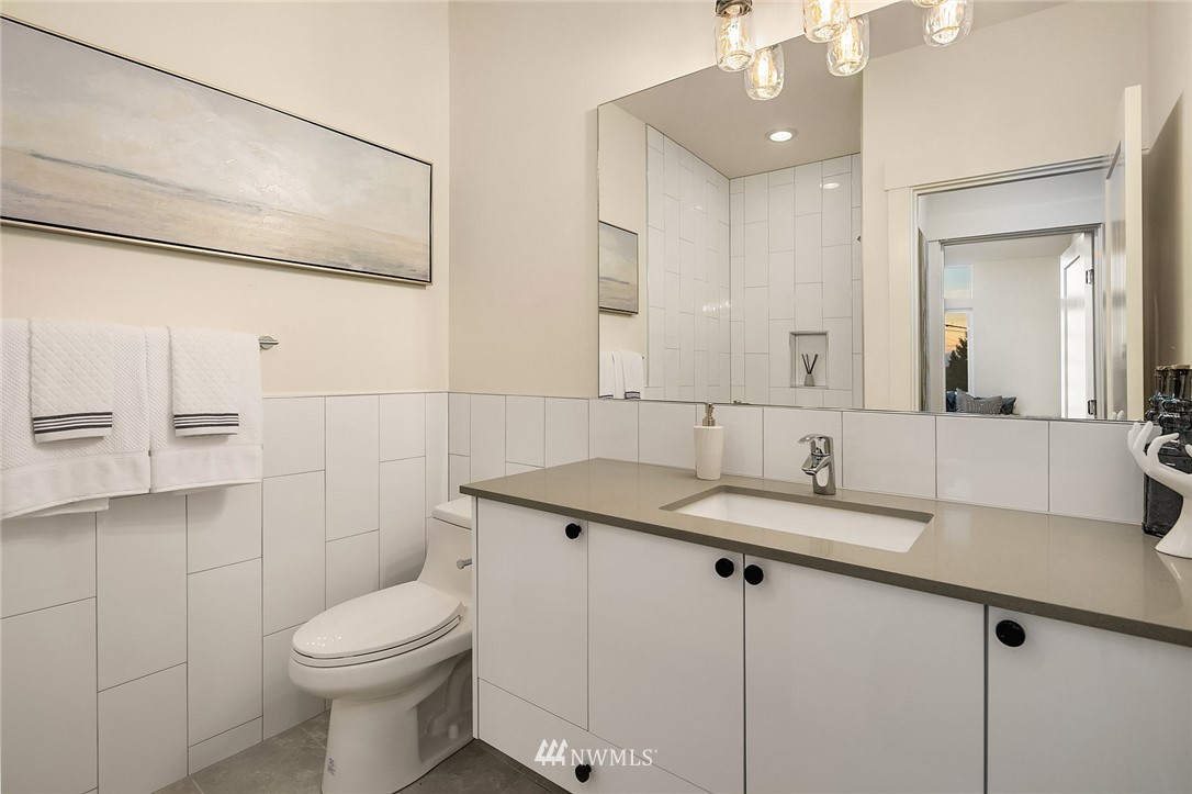 1306 Yakima Avenue South Seattle, WA 98144 - Photo 17 of 29 a bathroom with a granite countertop sink a toilet and mirror
