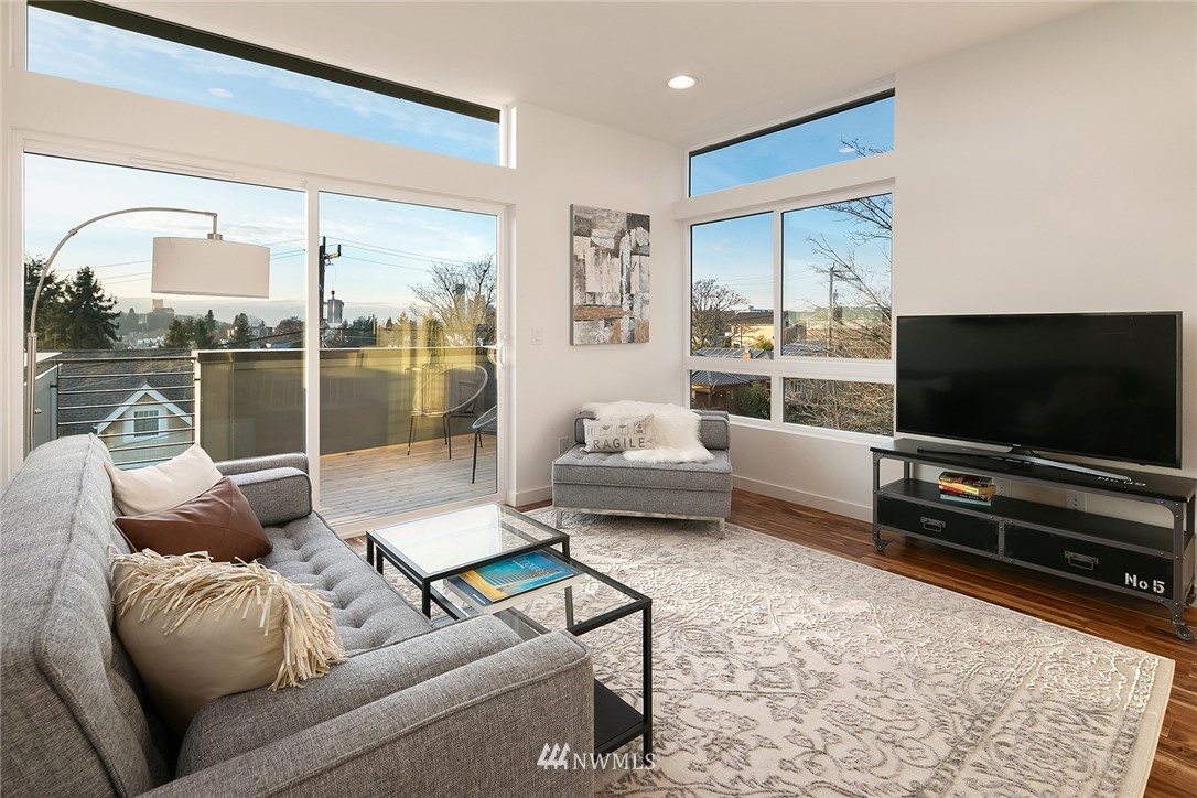 1306 Yakima Avenue South Seattle, WA 98144 - Photo 6 of 29 a living room with furniture a flat screen tv and a floor to ceiling window