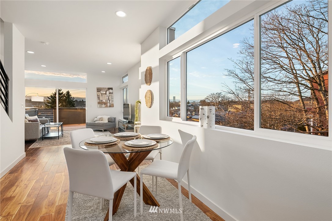 1306 Yakima Avenue South Seattle, WA 98144 - Photo 9 of 29 a dining room with furniture and a floor to ceiling window