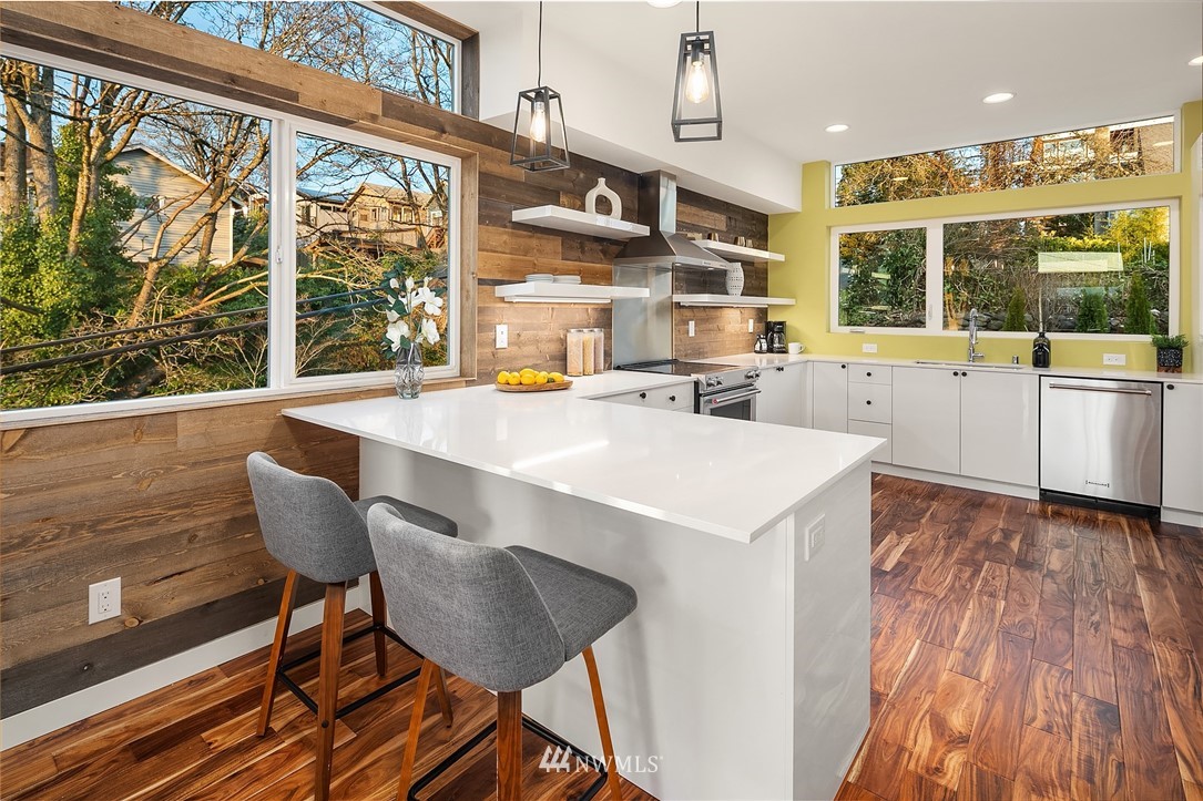 1306 Yakima Avenue South Seattle, WA 98144 - Photo 10 of 29 a kitchen with stainless steel appliances granite countertop a stove a sink and a microwave