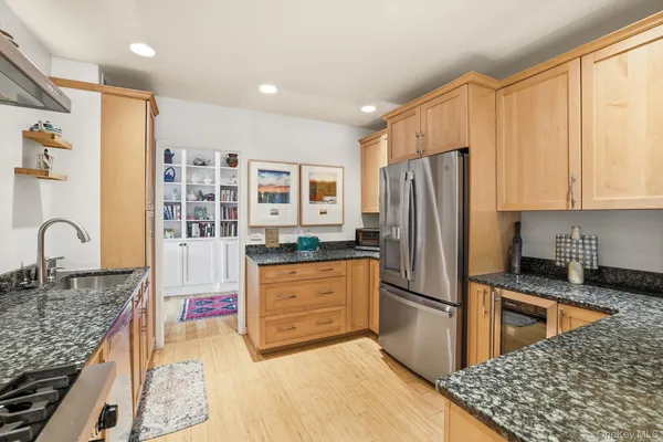 a kitchen with stainless steel appliances granite countertop a refrigerator sink and cabinets