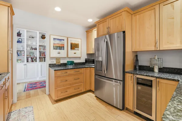 a kitchen with granite countertop cabinets and window