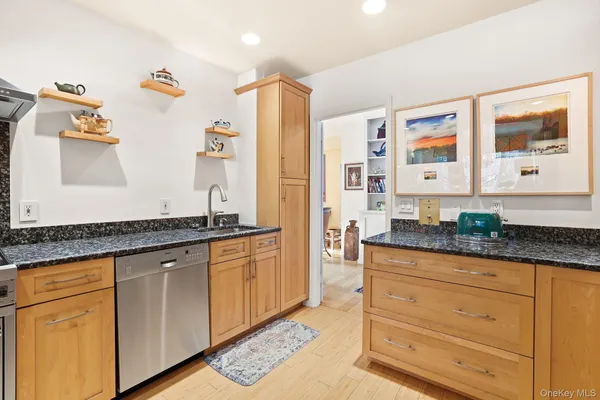 a kitchen with stainless steel appliances granite countertop a stove and a sink