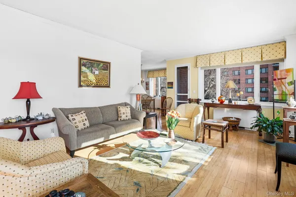 a living room with furniture a large window with kitchen view