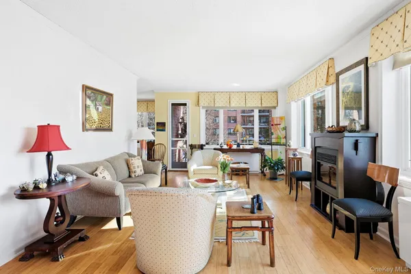a living room with furniture a fireplace and a large window