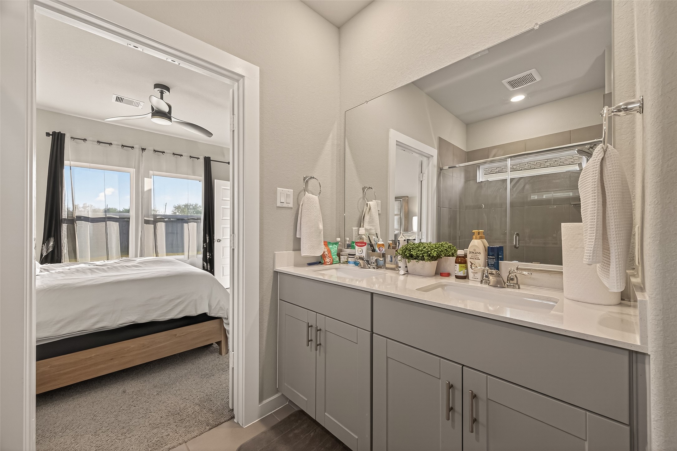 5516 Madden Lane Houston, TX 77048 - Photo 17 of 33 a en suite bathroom with a double vanity sink and mirror