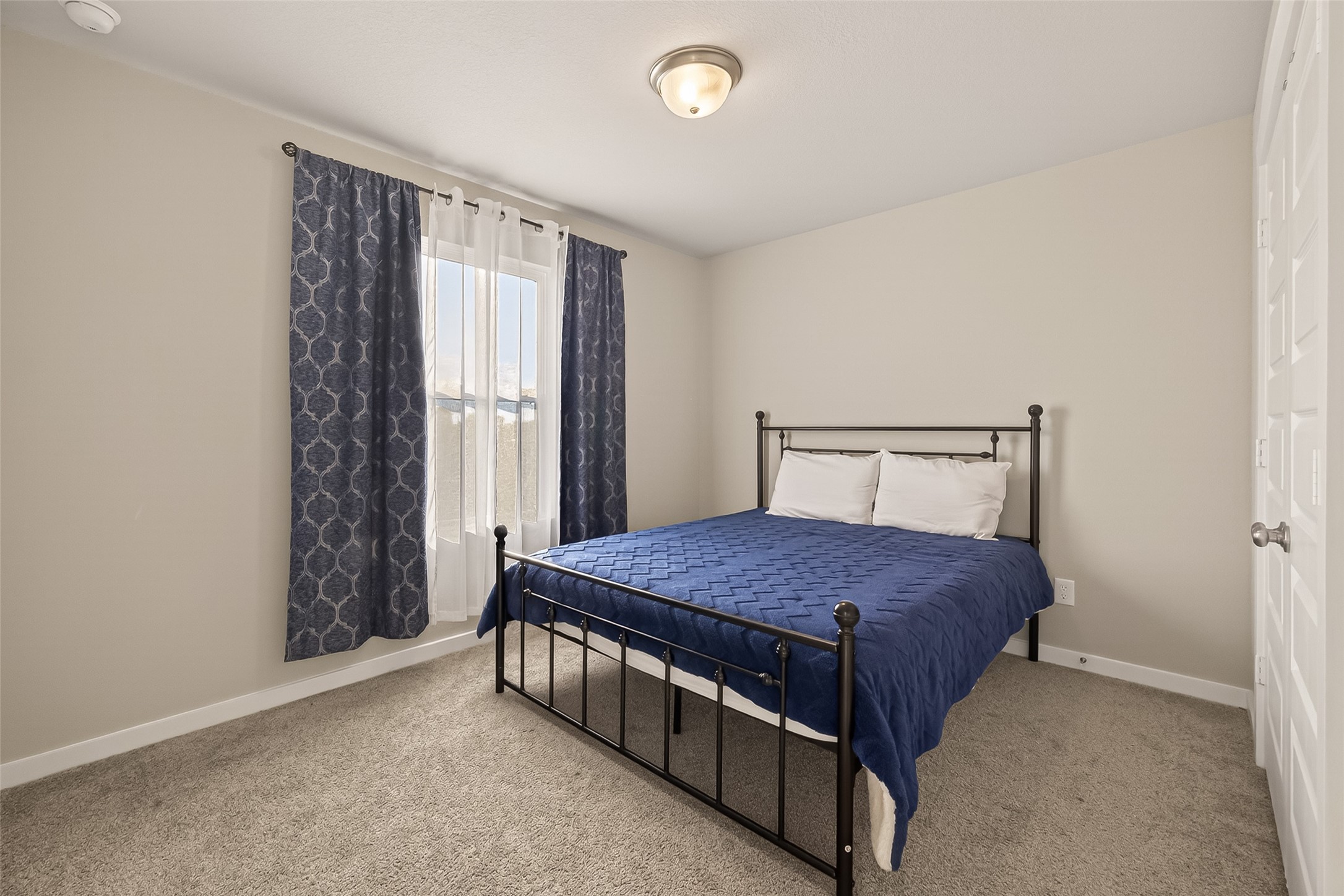 5516 Madden Lane Houston, TX 77048 - Photo 27 of 33 a bedroom with a bed and window