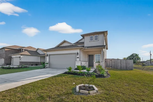 a view of a house with a yard and a tree