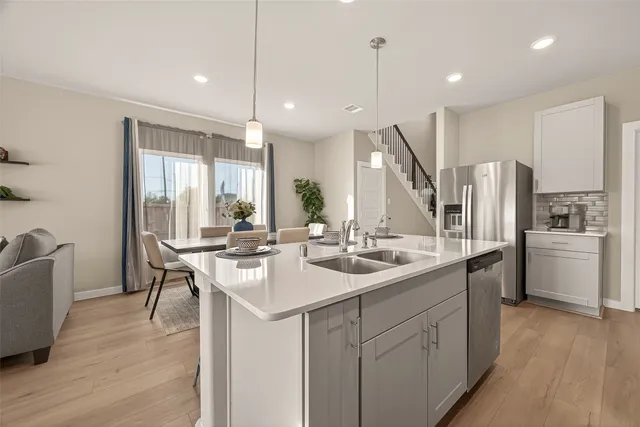 a kitchen with stainless steel appliances granite countertop a sink and stove